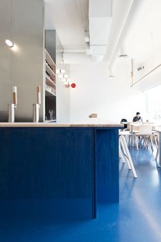 a kitchen with blue floors and white walls