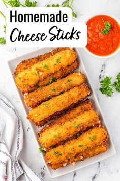 homemade cheese sticks on a plate with sauce and parsley