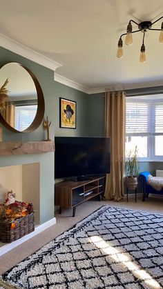 a living room filled with furniture and a flat screen tv on top of a fireplace