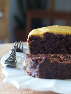 a piece of cake sitting on top of a white plate next to a knife and fork