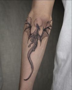 a man with a dragon tattoo on his arm