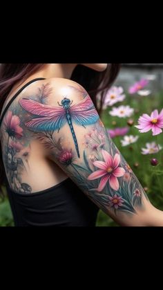 a woman's arm with flowers and a dragonfly tattoo on the back of her shoulder