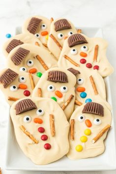 decorated cookies with frosting and candy eyes on a white plate