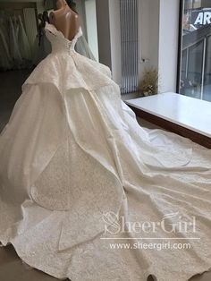 a wedding dress on display in front of a window