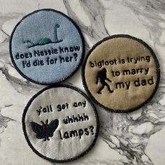 three embroidered patches with different sayings on them