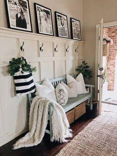 a bench with pillows and pictures on the wall