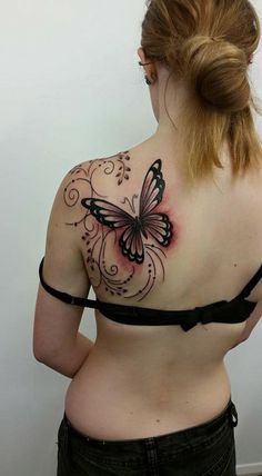 a woman with a butterfly tattoo on her back shoulder and upper part of her body