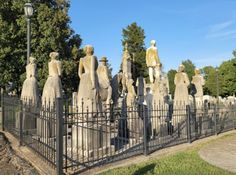 a group of statues sitting on top of a cemetery