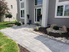 a house with landscaping in the front yard and walkway leading up to the front door