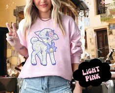 🐑 Stay Cute with our super cute kitschy vintage-inspired sweatshirt with our hand-drawn midcentury retro lamb illustration. We couldn't find the cute designs we wanted here on Etsy, so we created our own! This sweet pastel lamb illustration pairs perfectly with a super cozy oversized unisex sweater. This cute top is great for everyday wear or gifting to your favorite farm girl or cute friend.   🐑DETAILS 🌸 Cute hand-drawn graphic 🌸 Medium-heavy fabric 🌸 Loose fit 🌸 Runs true to size 🌸 50% cotton, 50% polyester  🐑SIZING This cozy sweatshirt is in UNISEX sizing. Those who prefer a more fitted, tighter sweatshirt may want to size down. Please see the size chart above.  🐑 ABOUT US Our professional, in-house art team lovingly designs all our whimsical tees. The tees are printed to order Cute Pink Sweatshirt As Gift, Cute Pink Sweatshirt For Gift, Retro Pink Graphic Print Sweatshirt, Retro Pink Sweatshirt With Graphic Print, Cute Graphic Print Sweater With Relaxed Fit, Cute Pink Sweater With Cartoon Print, Cute Graphic Print Sweatshirt For Gift, Retro Cartoon Print Sweatshirt, Cute Cartoon Print Spring Sweater