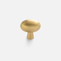 an antique brass knob on a white background, with the top half turned to look like it has been painted gold