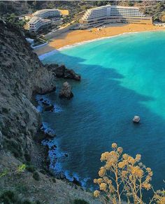 an aerial view of the blue water and beach