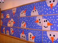 the wall is decorated with snowmen and faces on blue paper, surrounded by white stars