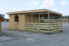 a small wooden building sitting in the middle of a parking lot