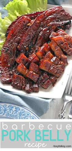 pork belly recipe on a plate with lettuce and salad in the background text reads pork belly recipe