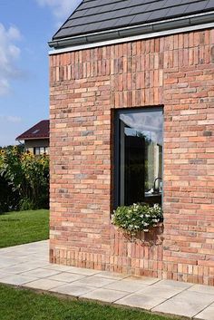 a brick building with a flower box in the window