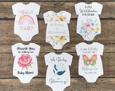 six baby onesuits with different designs on them