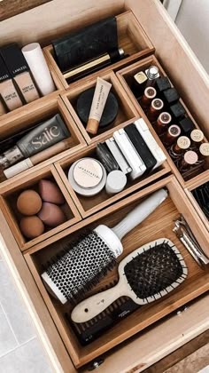 an organized drawer with hair brushes and other items