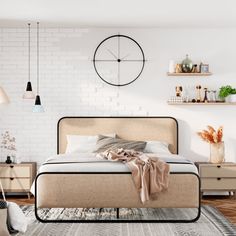 a bedroom with white brick walls and wooden flooring, a large bed in the center