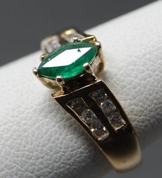 7 x 3.75mm marquis Emerald in great color. 12 Diamonds in an off set shoulder design. A really elegant ring showing light wear. 1.66 dwt. Update: Per customer request, Had Karin take a look at the stone. Excellent stone with a tiny chip on the girdle. Through a 10X loupe to find it. Adjusting price accordingly Classic Marquise Emerald Ring, Classic Formal Marquise Emerald Ring, Classic Formal Emerald Marquise Ring, Marquise Emerald Ring For Formal Occasions, 14k Gold Marquise Cut Emerald Ring, Marquise Emerald Ring With Prong Setting For Formal Occasions, Formal Marquise Emerald Ring With Prong Setting, Classic Emerald Ring Marquise Cut, Classic Marquise Cut Emerald Ring For Anniversary