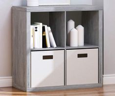 a book shelf with two bins and some books on the bottom one is open