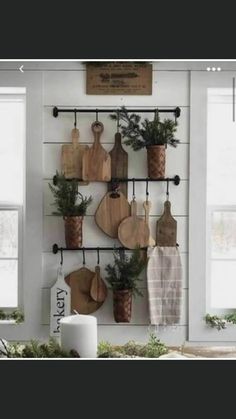 the kitchen is decorated for christmas with wood utensils and greenery hanging on the wall