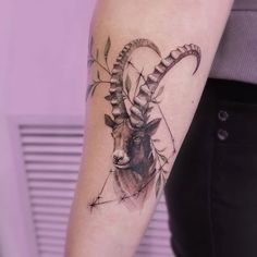 a goat head tattoo on the arm