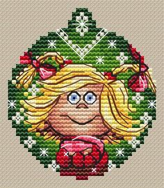 a cross stitch pattern with a blonde haired girl holding a cup in front of a christmas ornament