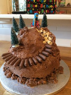 a birthday cake with chocolate frosting and decorations