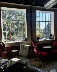 a living room filled with furniture and windows