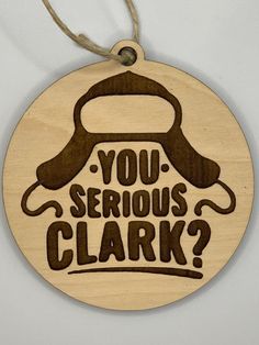 a wooden ornament that says, you serious clark?