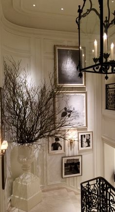 a room with pictures on the wall and a chandelier