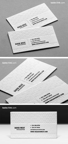 some white business cards with black and white designs on the front, back and sides