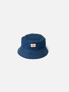 Bucket hat made from organic and recycled cotton. At 80% virgin organic cotton, the tightly woven lightweight denim offers great durability.  Kids grow, but clothes don't. When the hat is outgrown, hand it down. Or trade it in at any Nudie Jeans Repair Shop!     Interested to know more about our Utility Denim? Happy to hear it:  Nudie Jeans Utility Denim is our take on the denim of the best chore coats, dungarees, and carpenters' pants from the 1930s, which utilizes fine, high-twist yarns togeth Pre-washed Cotton 5-panel Hat, Blue Cotton Wide Brim Hat, Blue Cotton Bucket Hat For Outdoor, Blue Cotton Sun Hat For Outdoor Use, Blue Cotton Sun Hat For Outdoor, Blue Washed Hat With Curved Brim, Pre-washed 5-panel Cotton Hat, Washed Blue Cotton Cap, Everyday Washed Hat With Curved Brim