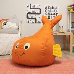 an inflatable orange fish pillow sitting on the floor next to a child's bed