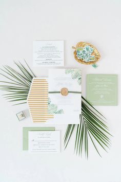 the wedding stationery is laid out on top of each other