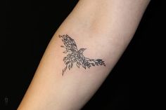 a small tattoo on the arm of a woman's left arm, with leaves growing out of it