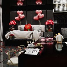 a bedroom decorated in black and white with red balloons