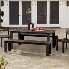 a wooden table and chairs sitting on a patio