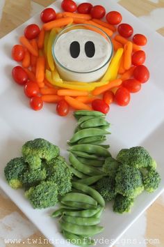 a white plate topped with broccoli and carrots