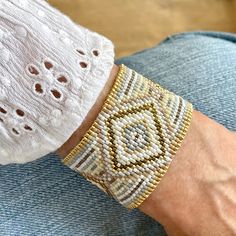 a close up of a person's arm wearing a bracelet with beads on it