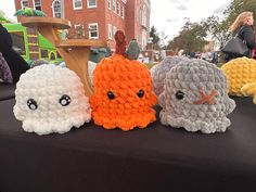 three crocheted stuffed animals sitting on top of a table next to each other