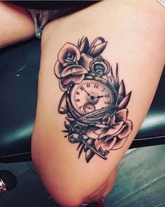 a woman's thigh with a clock and roses tattoo on it