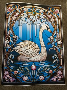 a stained glass window with a swan on it