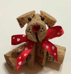 a dog made out of wine corks with a red bow