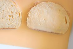 two slices of bread sitting on top of a yellow countertop next to each other