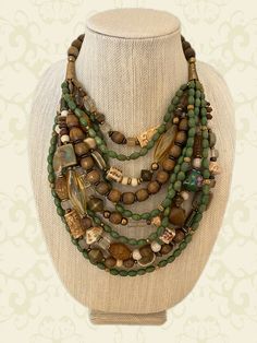 Multi-Strand Mixed Beads and Brass Statement Necklace – Sharon Cipriano Jewelry Multi-strand Wooden Beads For Jewelry Making, Unique Multi-strand Necklaces With Spacer Beads, Unique Multi-strand Necklace With Spacer Beads, Green Multi-strand Hand-strung Necklaces, Green Multi-strand Wooden Beads Jewelry, Wooden Multi-strand Beads For Jewelry Making, Earthy Spacer Beads For Jewelry Making, Artisan Multi-strand Jewelry With Spacer Beads, Unique Hand-strung Multi-strand Necklace