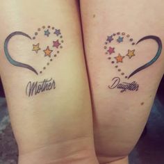 two matching tattoos with the words mother and daughter written on their arms in heart shapes