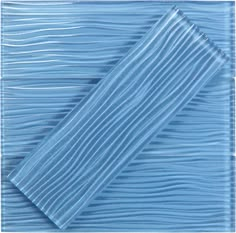 a blue glass tile with wavy lines on it