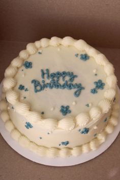 a birthday cake with frosting and blue decorations